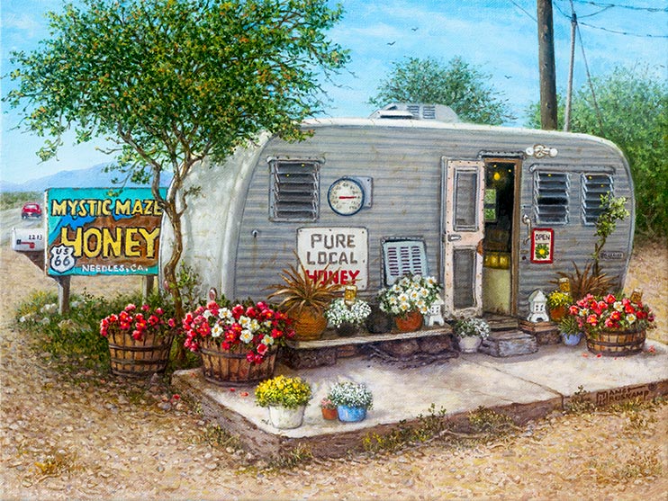 A small well-worn travel trailer sits alongside Route 66 in Needles, California, next to a sign offering Mystic Maze Honey for sale. Baskets, barrels and pots hold brightly colored flowers in front of the trailer and its open door. A thermometer hanging on the trailer shows a hot, 100 degree day, while a large sign advertises Pure Local Honey.