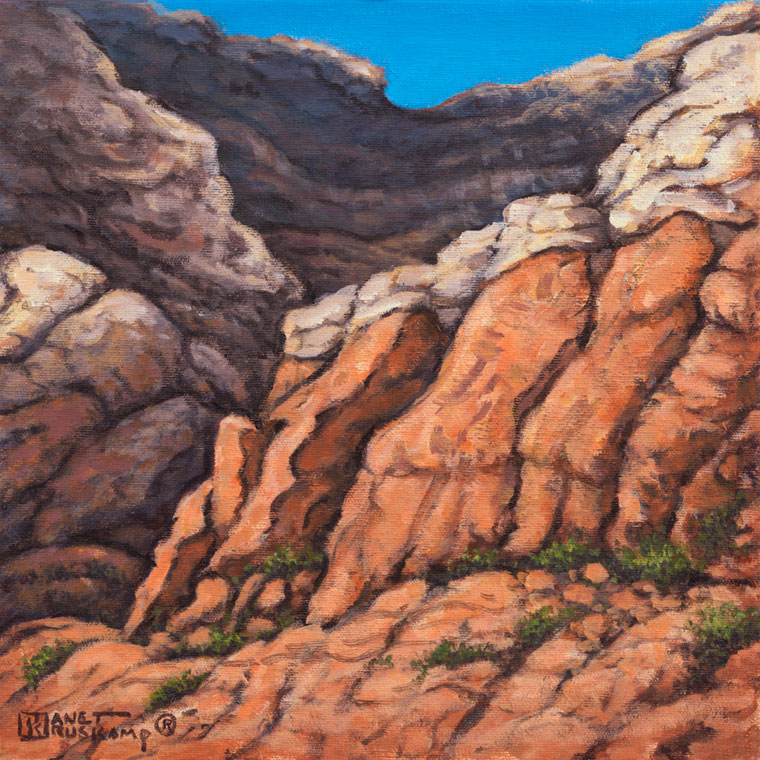 Red Rock Canyon #2, an acrylic landscape painting by renowned artist Janet Kruskamp. Vertical cracks lead up the weathered red sandstone canyon walls, the cracks populated by small plants wherever they can gain a foothold. A lighter colored rock with horizontal layers sits at the top of the steep canyon wall. One of the Interiors and Exteriors Gallery by Janet Kruskamp.
