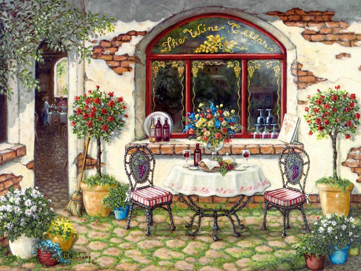 The Wine Cellar, a giclee , personally enhanced and by the artist Janet Kruskamp showing the front window, door and outdoor table of The Wine Cellar. The table is set with wine, bread and fruit. Pots and planters of brightly colored flowers surround the table and doorway. The outside wall around the front window shows the age of the building in the patches of missing plaster.