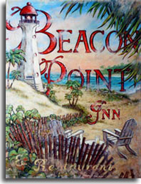 Beacon Point is another lush vintage travel poster from artist Janet Kruskamp. The beautiful seaside scene is anchored by a white lighthouse with a red cap that appears in front of the title of the poster in the upper left, overlooking the crystal blue bay and a sailboat skimming along the water. Two weathered wooden chairs at the base of the poster face forward towards the bay, a glass of lemonade sits on a small table between the chairs. The large type says Beacon Point Inn and Restaurant in weathered red. Palm trees sway in the wind across the bay to the point. Trees blown by the wind complete the poster in the upper right, showing you what a great day to be sailing.